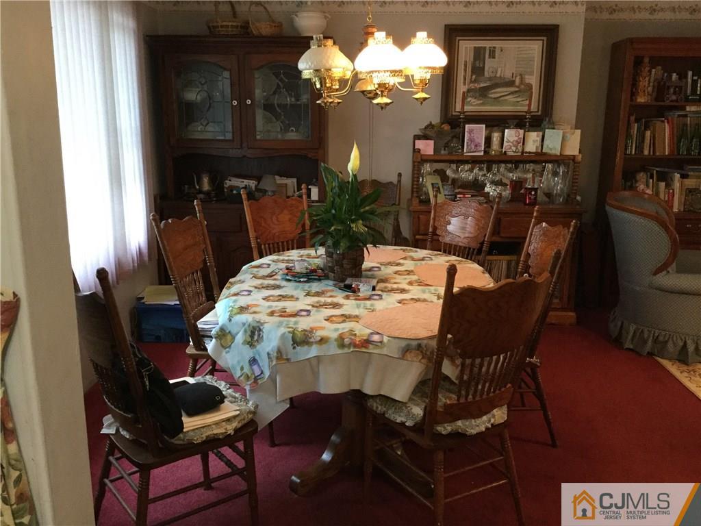 33 Idlewild Road Edison, NJ 08817 - Photo 12 of 16 a dining room with furniture and a chandelier