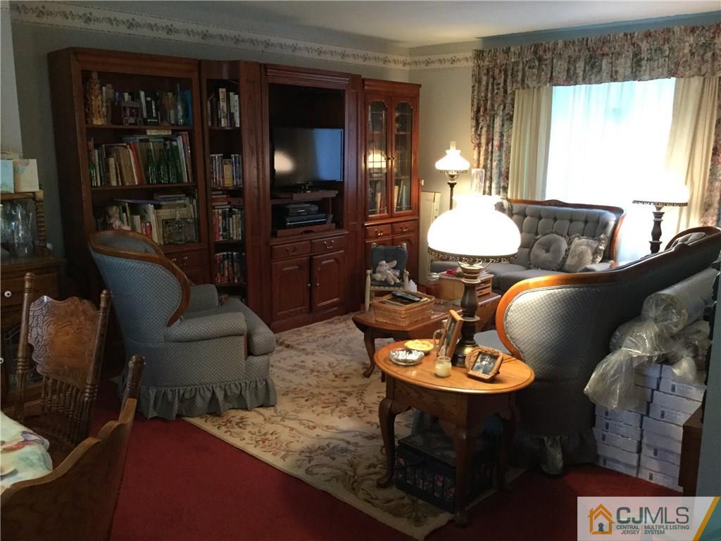 33 Idlewild Road Edison, NJ 08817 - Photo 13 of 16 a table room with furniture and a lamp