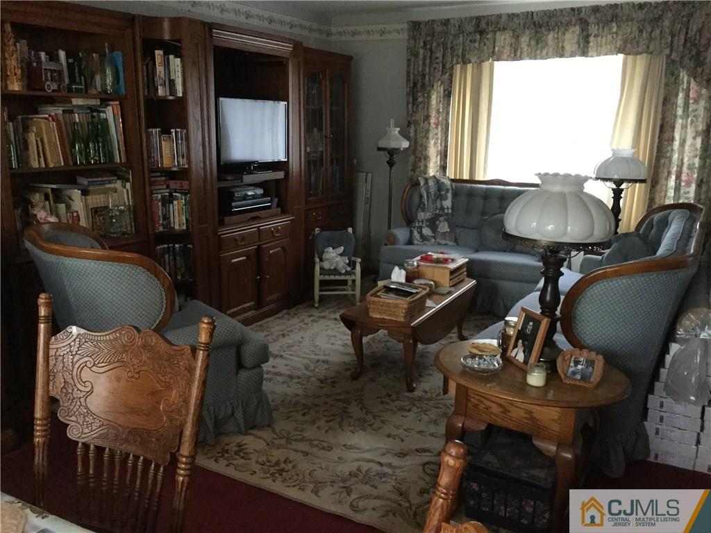 33 Idlewild Road Edison, NJ 08817 - Photo 3 of 16 a living room with furniture a window and a fireplace