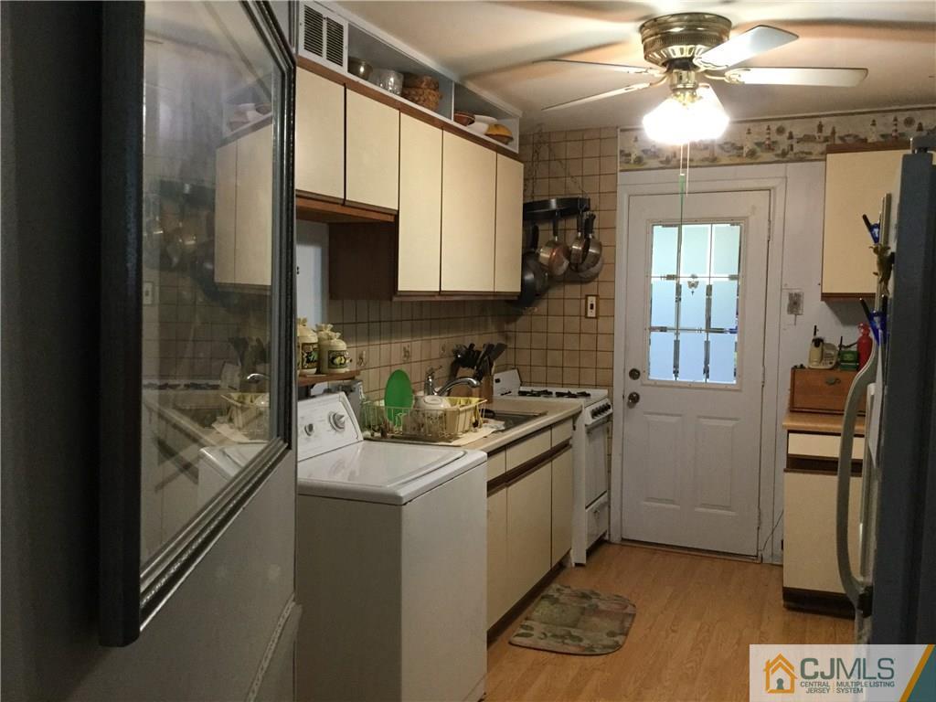 33 Idlewild Road Edison, NJ 08817 - Photo 4 of 16 a kitchen with stainless steel appliances granite countertop a sink a stove and a refrigerator