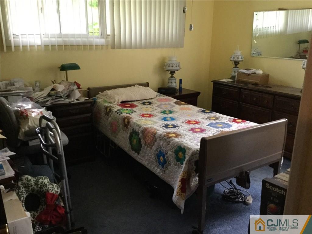 33 Idlewild Road Edison, NJ 08817 - Photo 5 of 16 a bed sitting in a bedroom next to a window