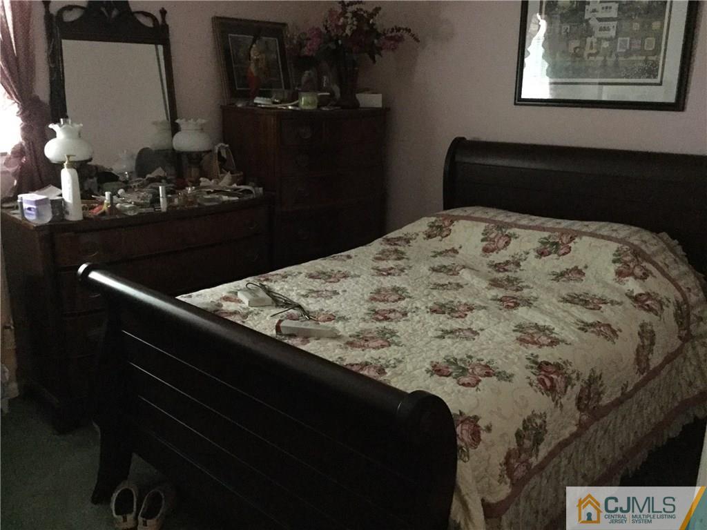 33 Idlewild Road Edison, NJ 08817 - Photo 6 of 16 a bed sitting in a bedroom next to a window
