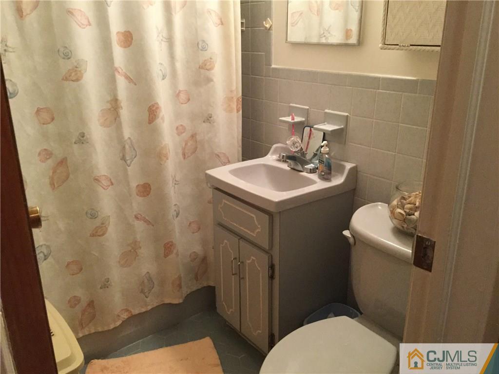 33 Idlewild Road Edison, NJ 08817 - Photo 7 of 16 a bathroom with a sink toilet and a mirror