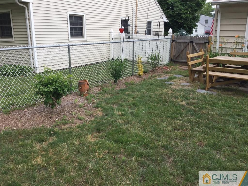 33 Idlewild Road Edison, NJ 08817 - Photo 10 of 16 a view of backyard with wooden fence and a large tree