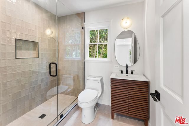 a bathroom with a toilet sink and shower