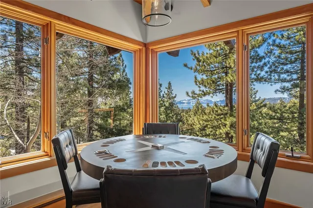 a living room with furniture large window and wooden floor