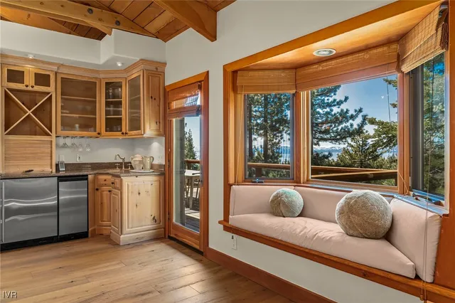 a living room with furniture flat screen tv and a large window