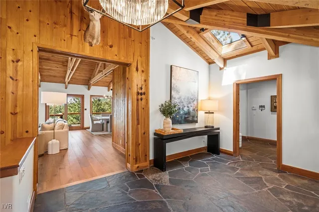 a room with pool table and windows