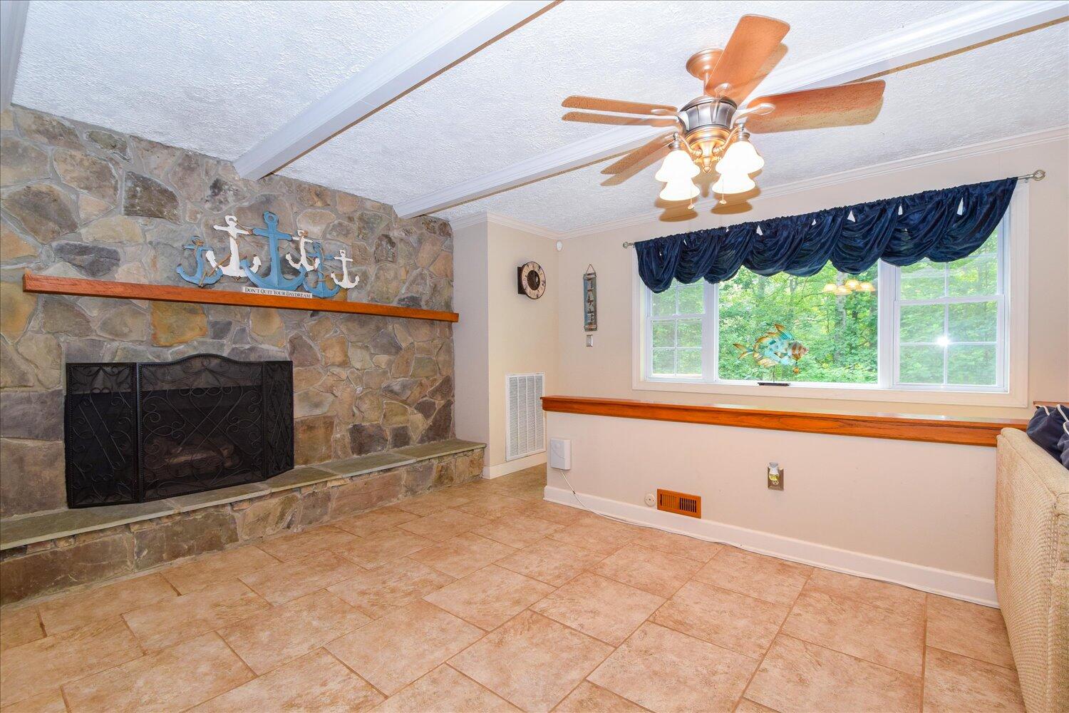 1851 Morris Road Goodview, VA 24095 - Photo 6 of 51 a view of an empty room with a fireplace and a window