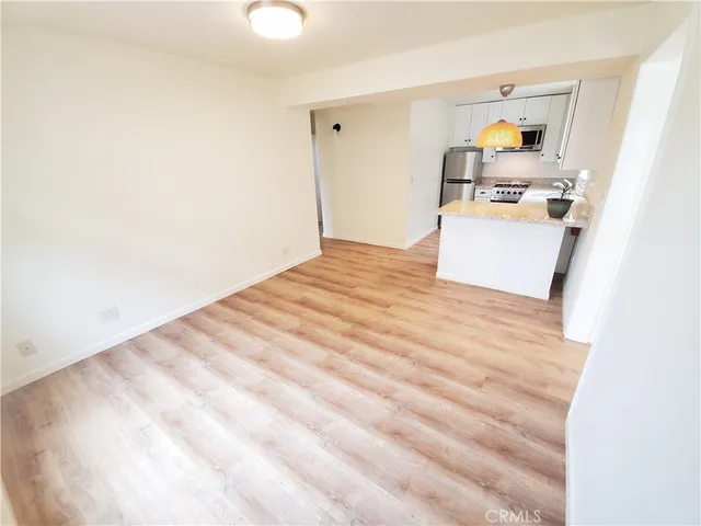a view of kitchen and wooden floor