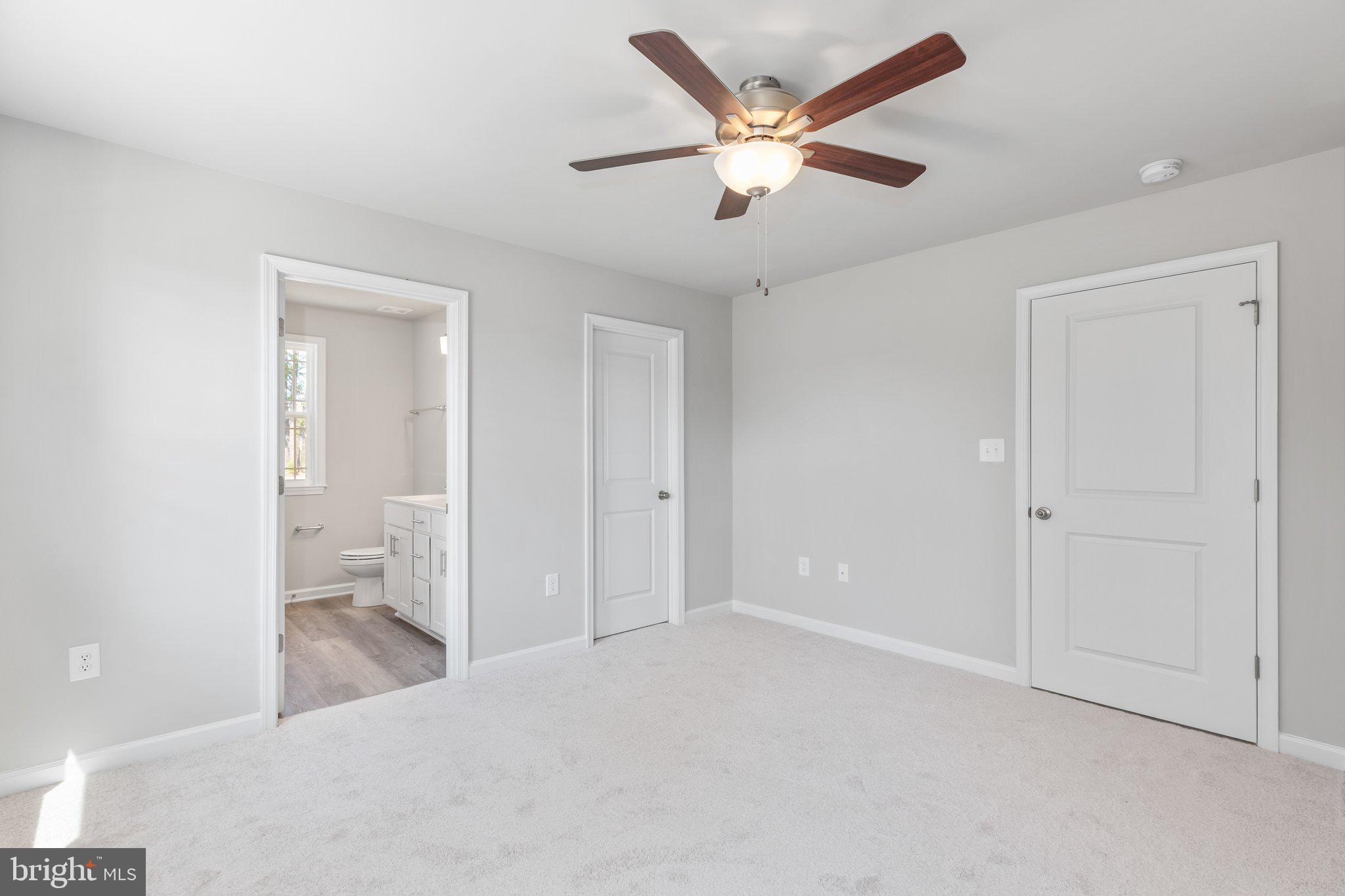 10 Azalea Way Colonial Beach, VA 22443 - Photo 11 of 36 an empty room with closet and a ceiling fan