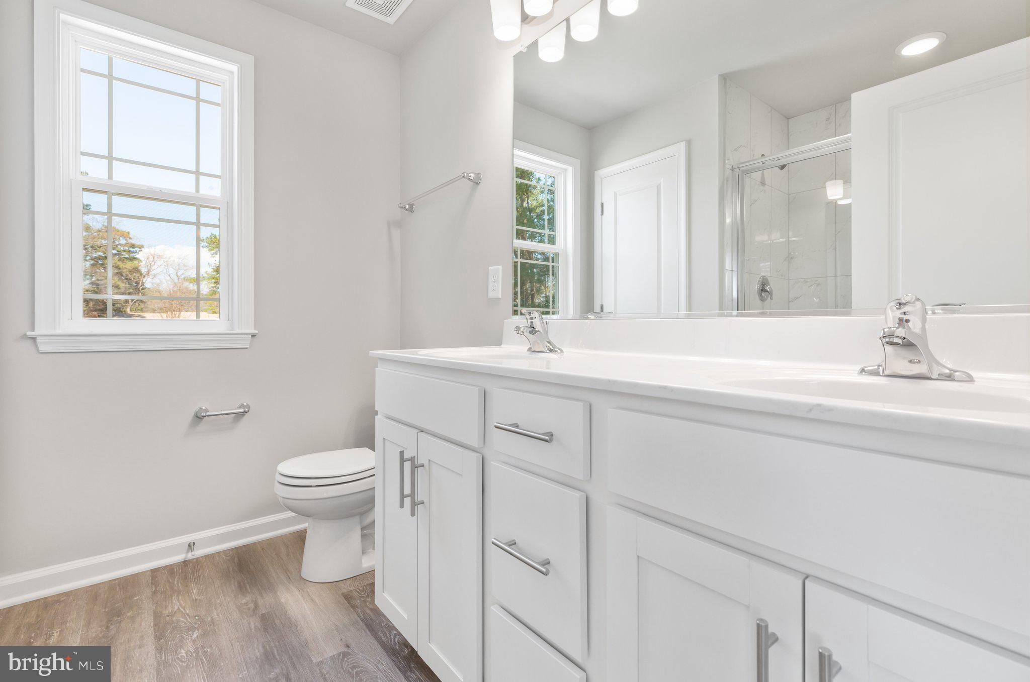 10 Azalea Way Colonial Beach, VA 22443 - Photo 12 of 36 a bathroom with a toilet sink and mirror