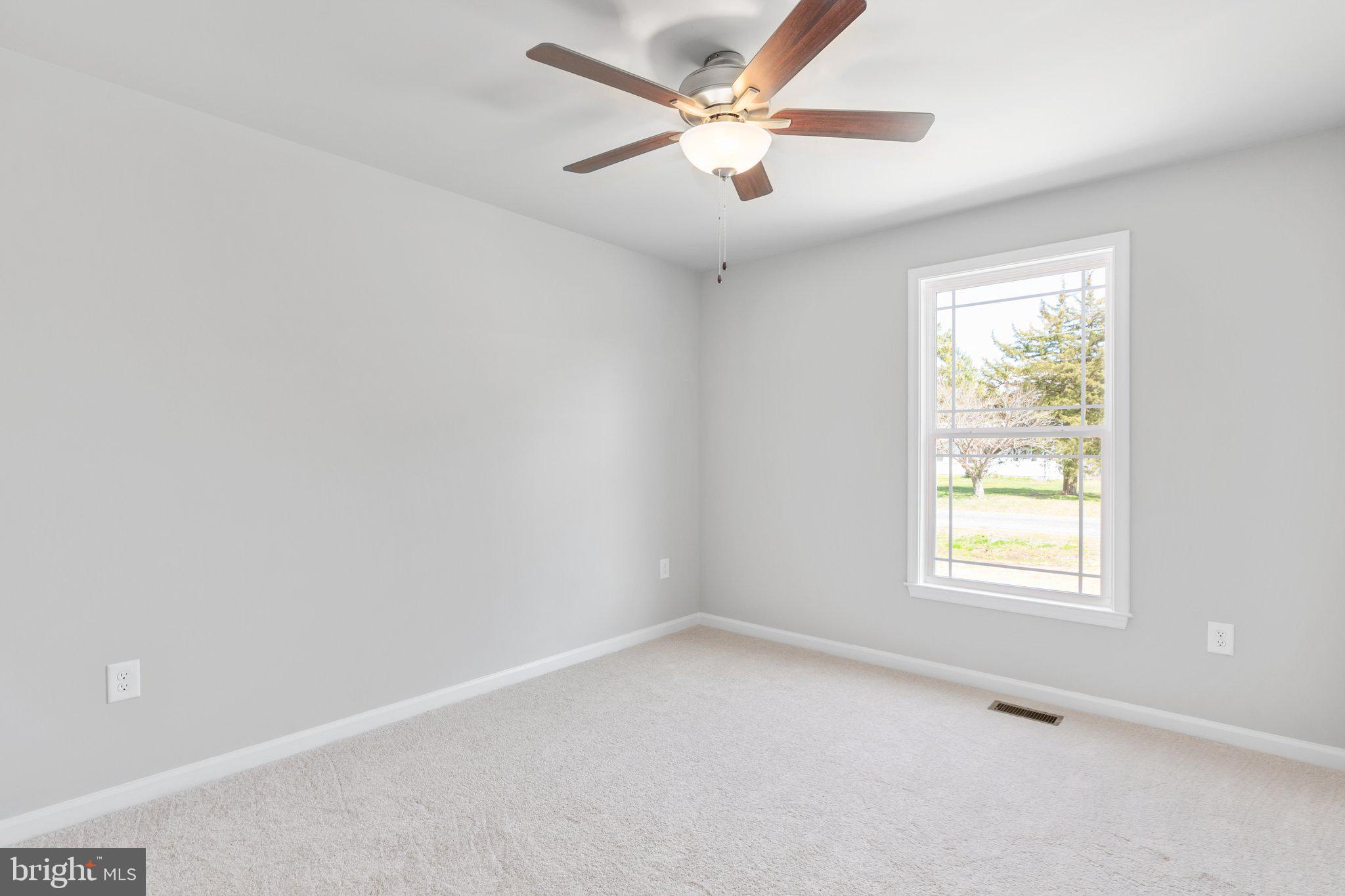 10 Azalea Way Colonial Beach, VA 22443 - Photo 16 of 36 an empty room with a window and a fan