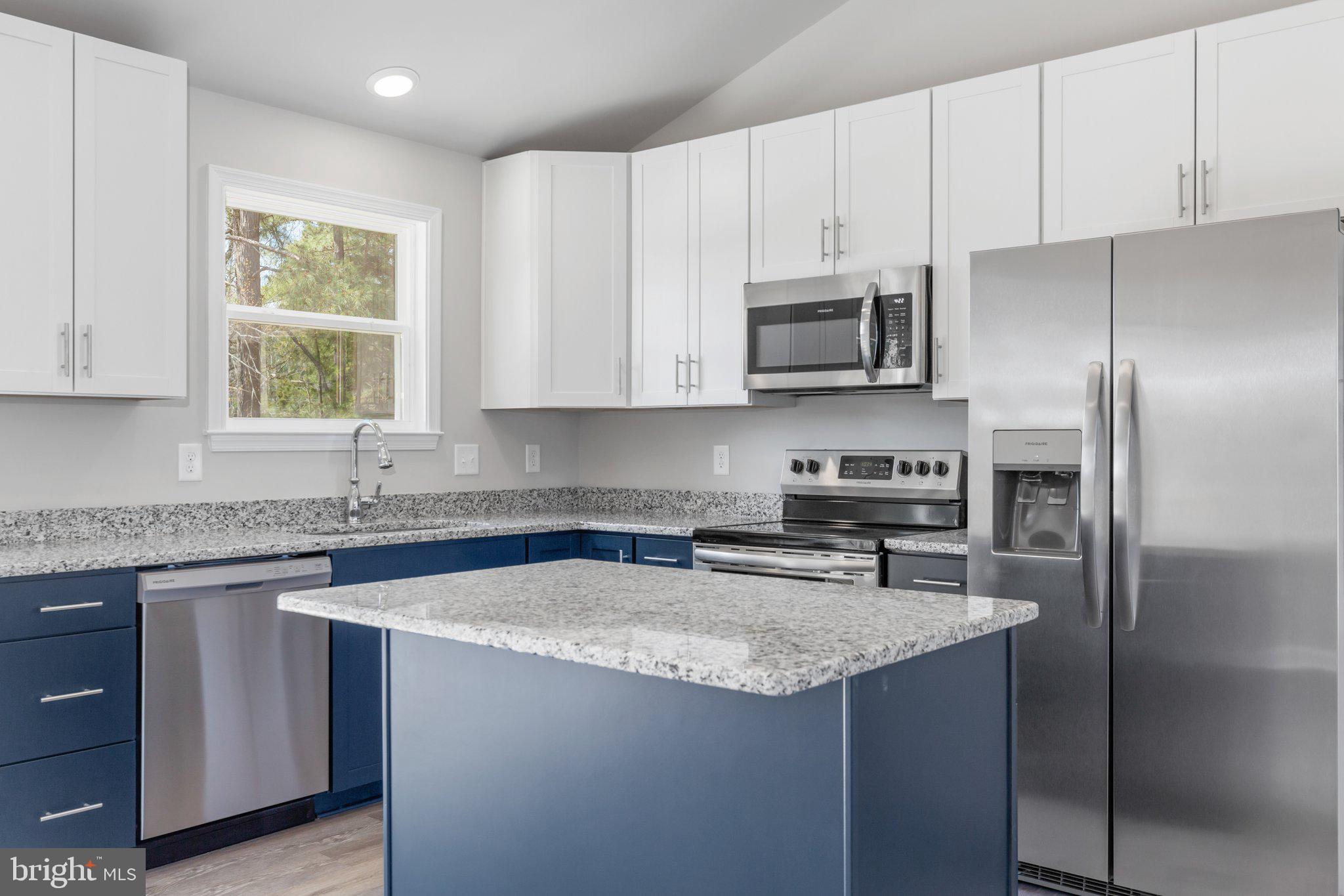 10 Azalea Way Colonial Beach, VA 22443 - Photo 2 of 36 a kitchen with stainless steel appliances granite countertop a sink stove microwave and refrigerator