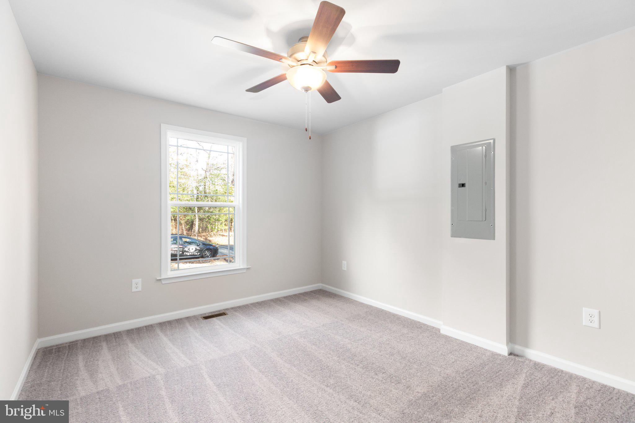 10 Azalea Way Colonial Beach, VA 22443 - Photo 21 of 36 an empty room with windows and fan