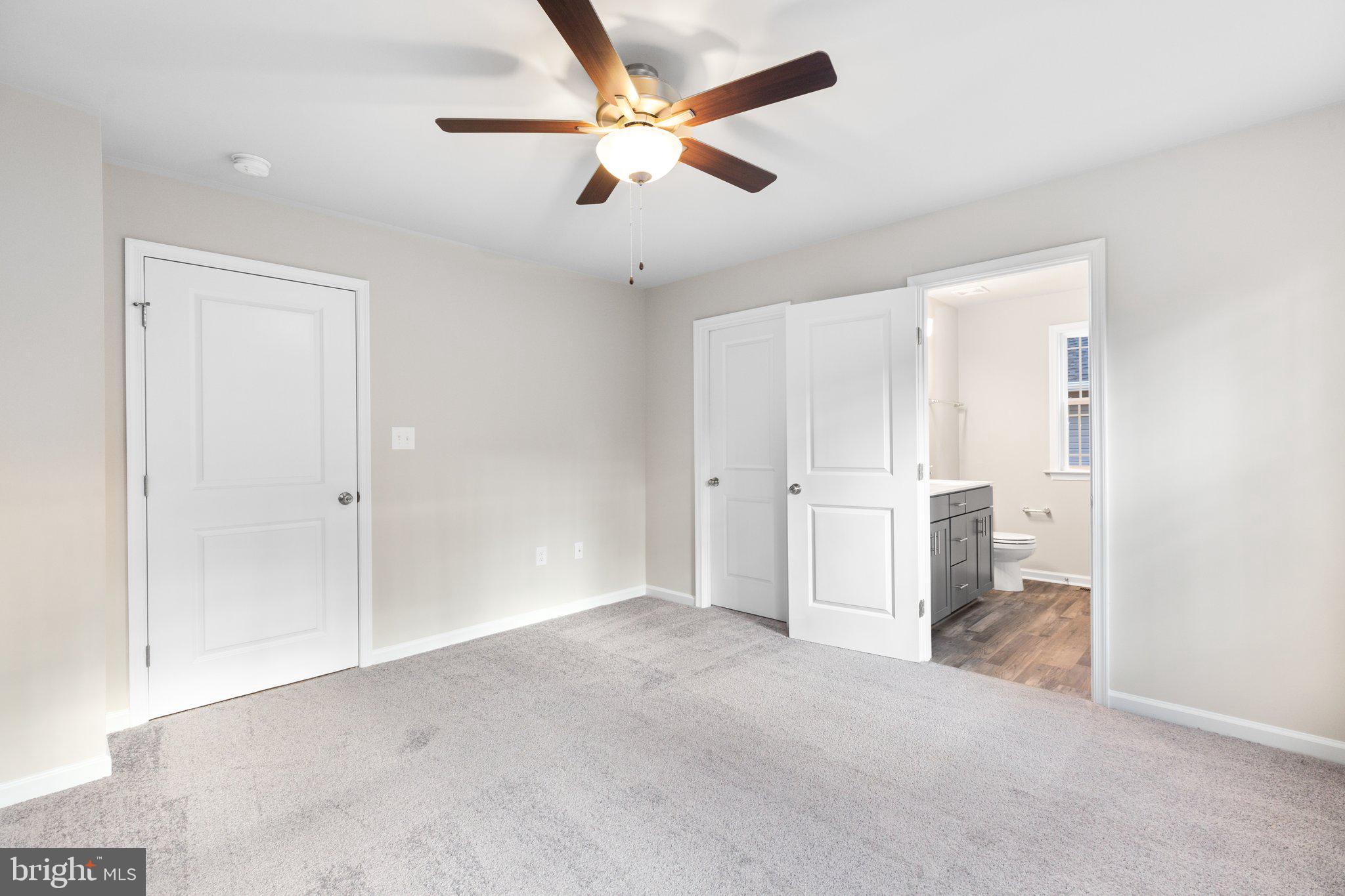 10 Azalea Way Colonial Beach, VA 22443 - Photo 26 of 36 an empty room with closet and a ceiling fan