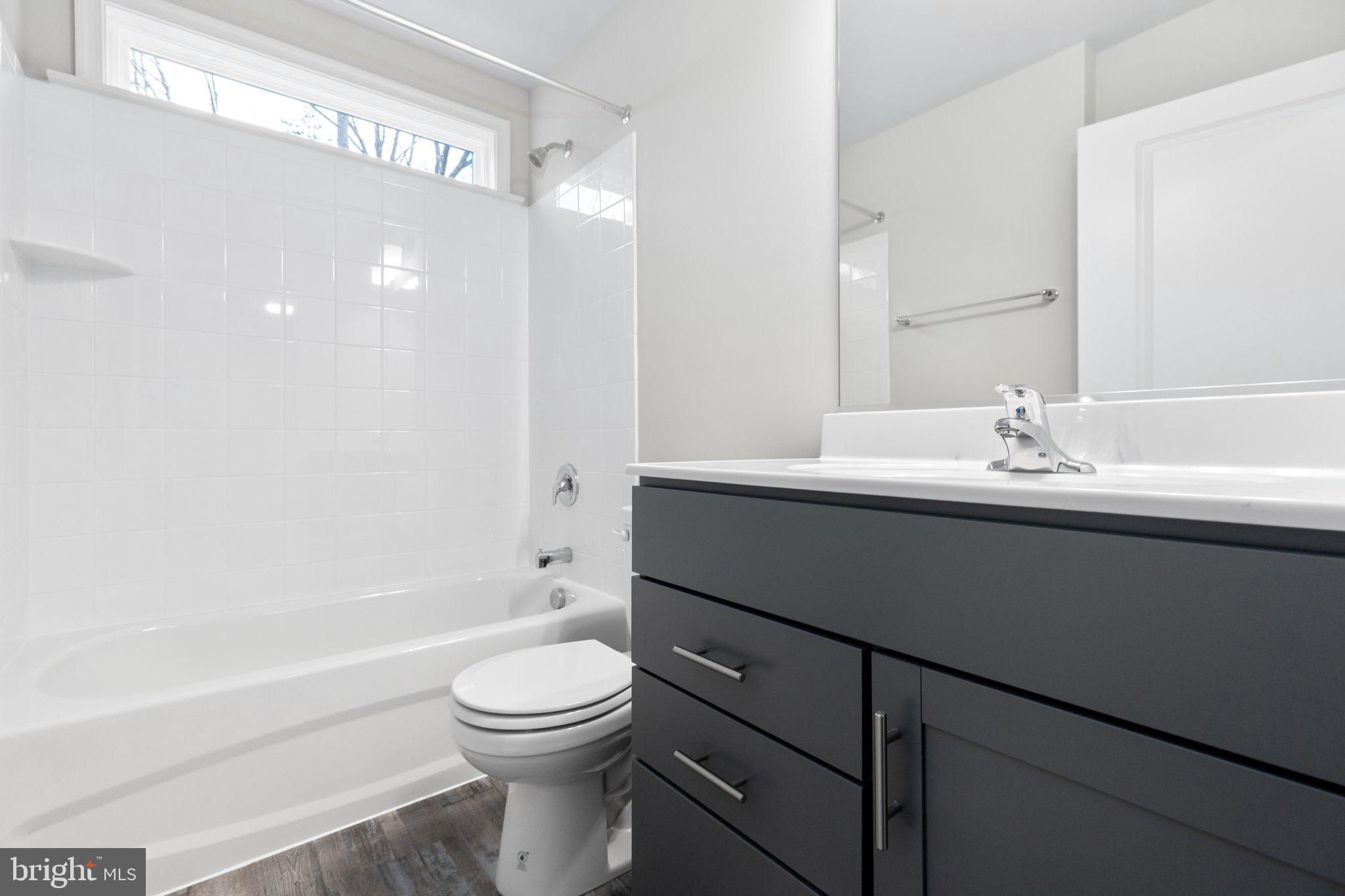 10 Azalea Way Colonial Beach, VA 22443 - Photo 28 of 36 a bathroom with a sink a toilet and shower