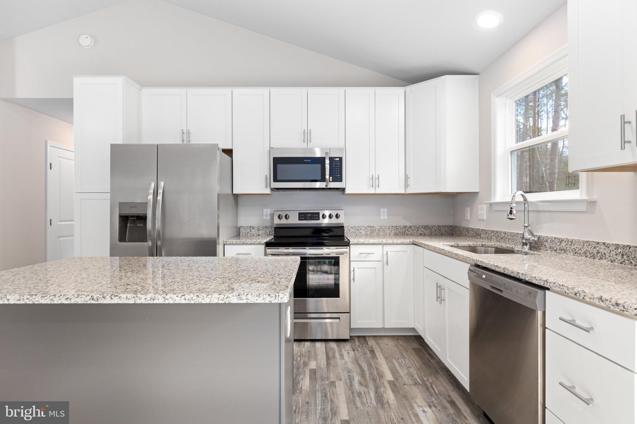 10 Azalea Way Colonial Beach, VA 22443 - Photo 33 of 36 a kitchen with granite countertop a refrigerator sink and microwave
