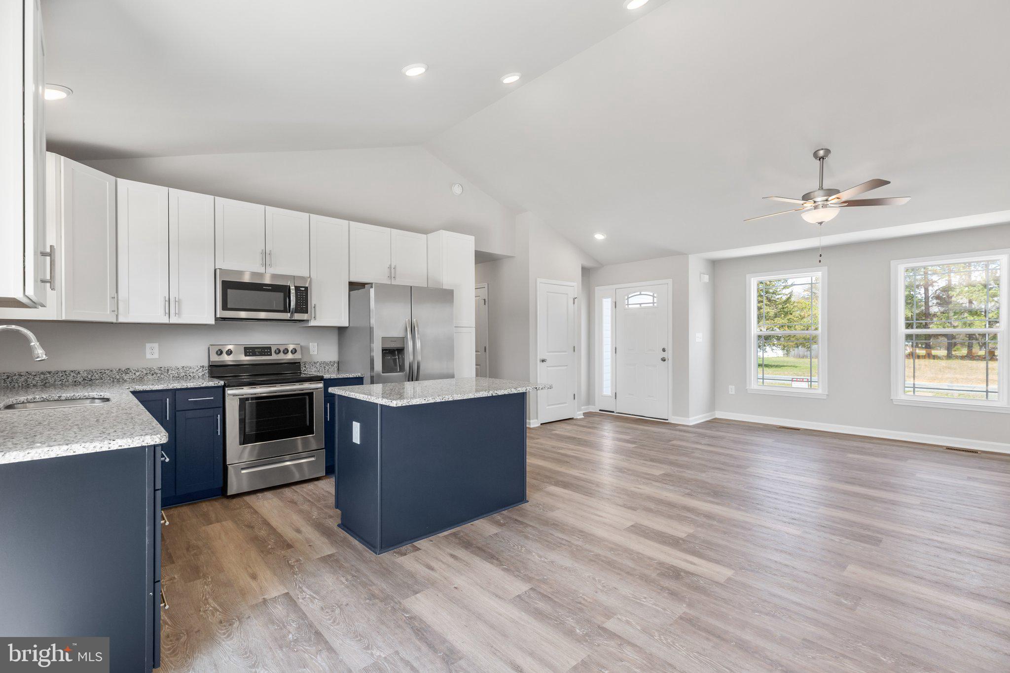 10 Azalea Way Colonial Beach, VA 22443 - Photo 6 of 36 a large kitchen with stainless steel appliances granite countertop a stove a sink dishwasher and a oven with white cabinets