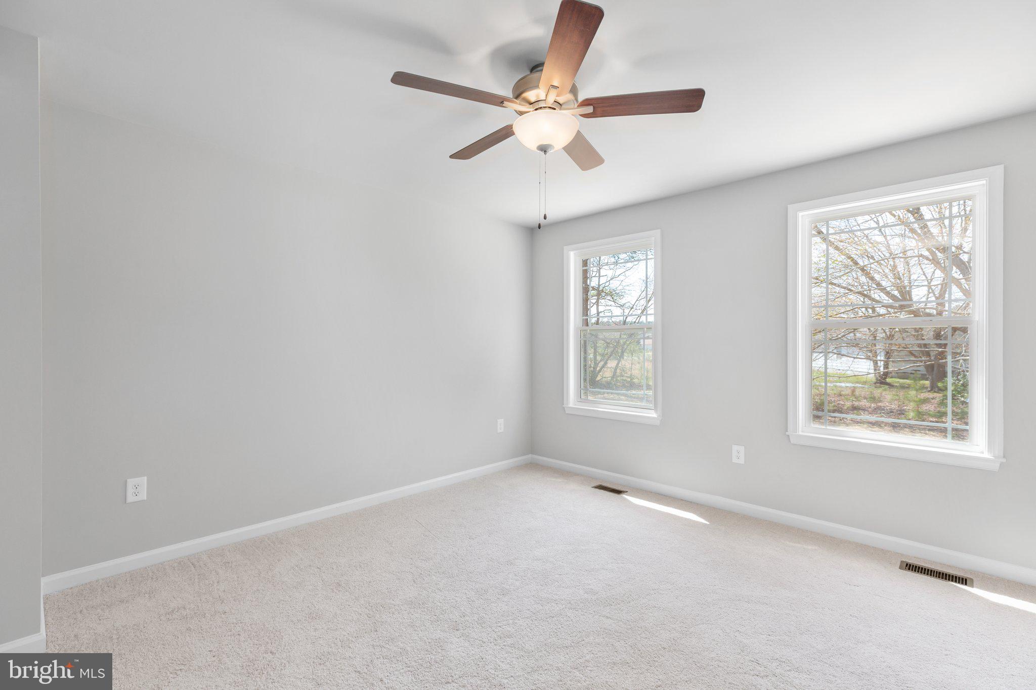 10 Azalea Way Colonial Beach, VA 22443 - Photo 10 of 36 an empty room with a window and a fan