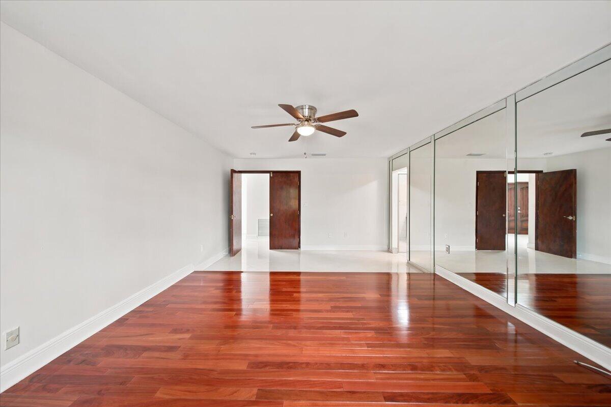 20009 Northwest 66th Place Hialeah, FL 33015 - Photo 17 of 33 a view of an empty room with wooden floor and a ceiling fan