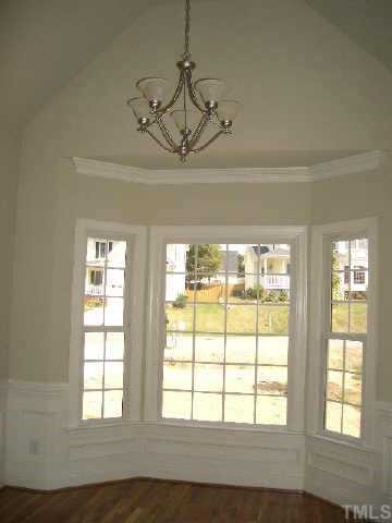 The dining room has a vaulted ceiling, wainscoting &amp; bay window - perfect ambience for entertaining.