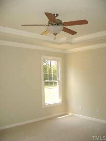 The spacious master bedroom has a lovely trey ceiling.