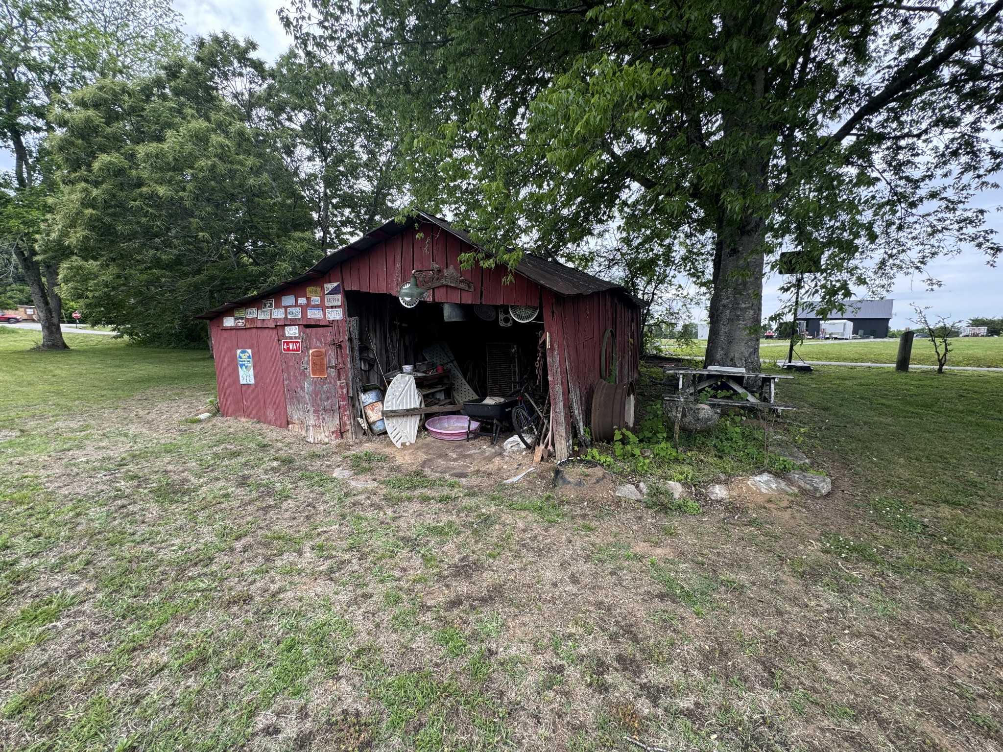 102 Sugar Tree Road Pulaski, TN 38478 - Photo 21 of 35 a view of a barn with big yard potted plants and large tree