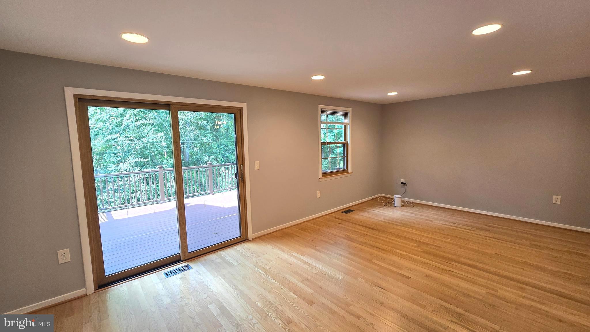 5987 Clerkenwell Court Burke, VA 22015 - Photo 11 of 41 an empty room with wooden floor and windows