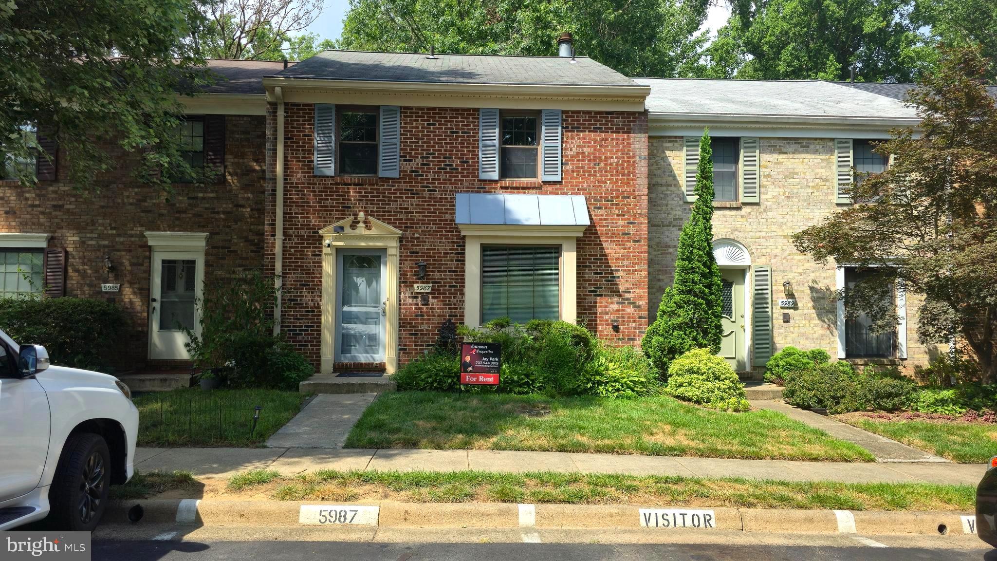 5987 Clerkenwell Court Burke, VA 22015 - Photo 2 of 41 a front view of a house with garden