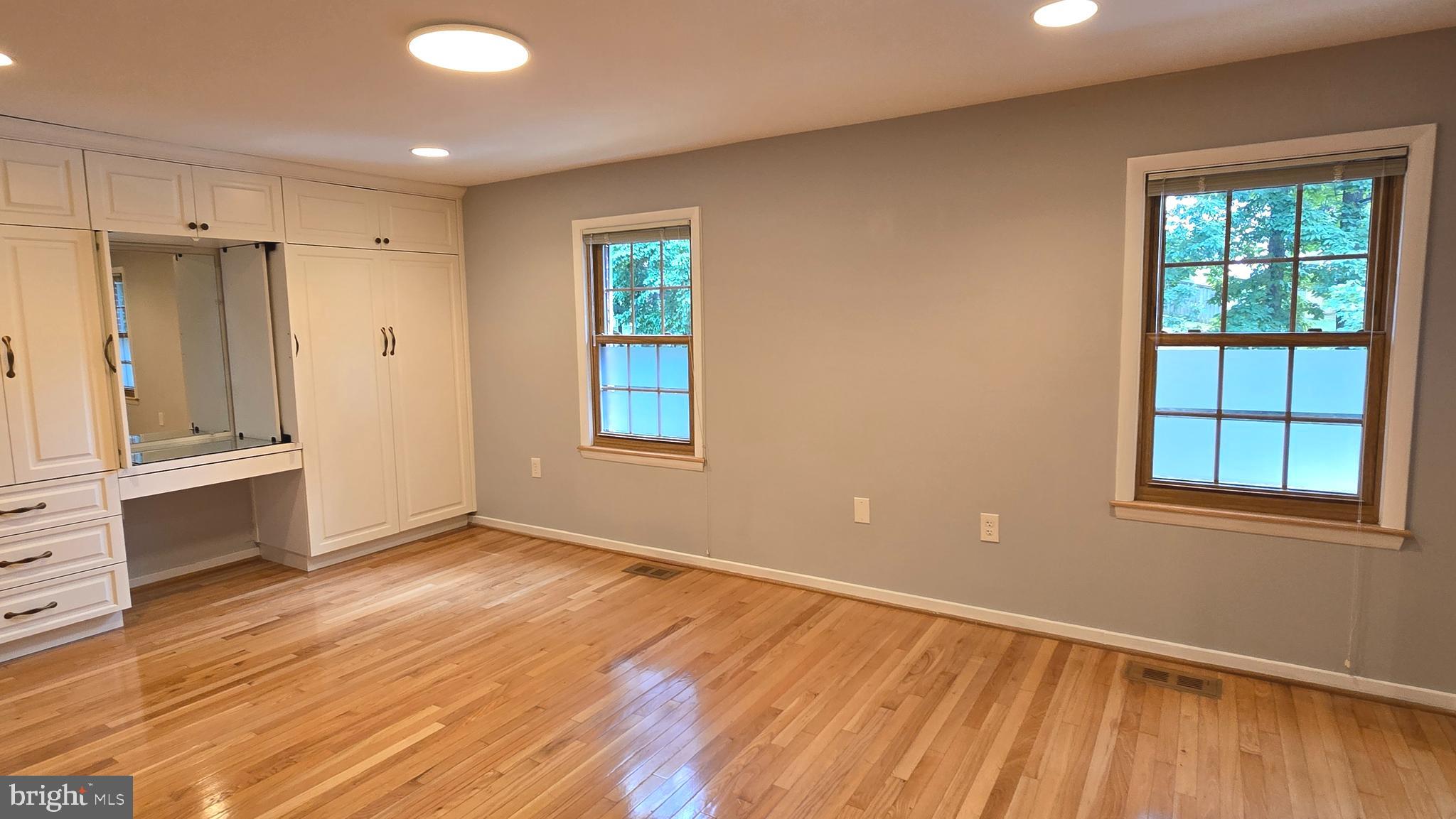 5987 Clerkenwell Court Burke, VA 22015 - Photo 21 of 41 wooden floor in an empty room with a window