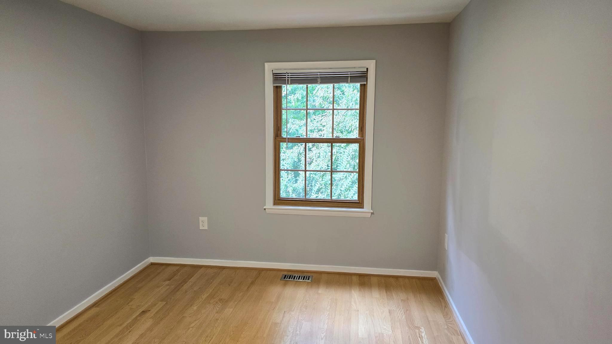 5987 Clerkenwell Court Burke, VA 22015 - Photo 26 of 41 an empty room with wooden floor and windows