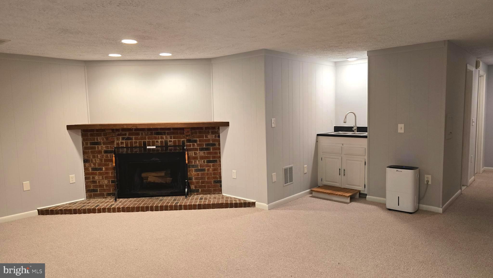 5987 Clerkenwell Court Burke, VA 22015 - Photo 32 of 41 an empty room with fireplace and window