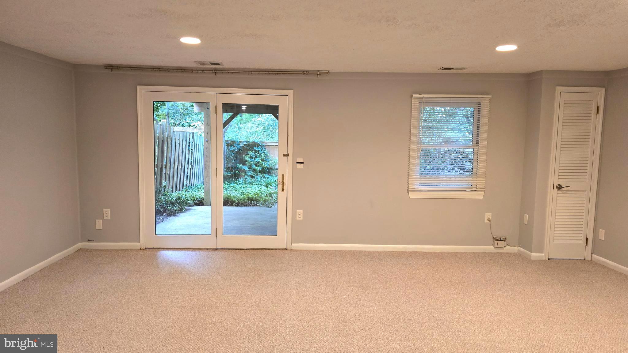 5987 Clerkenwell Court Burke, VA 22015 - Photo 33 of 41 an empty room with windows and outdoor view