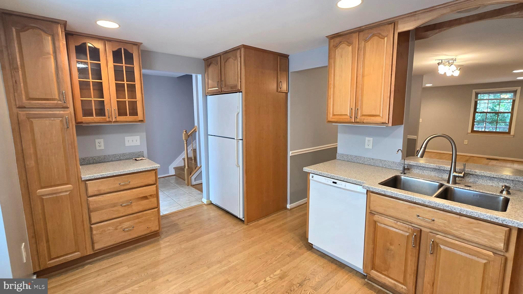 5987 Clerkenwell Court Burke, VA 22015 - Photo 4 of 41 a kitchen with stainless steel appliances granite countertop a refrigerator and a sink