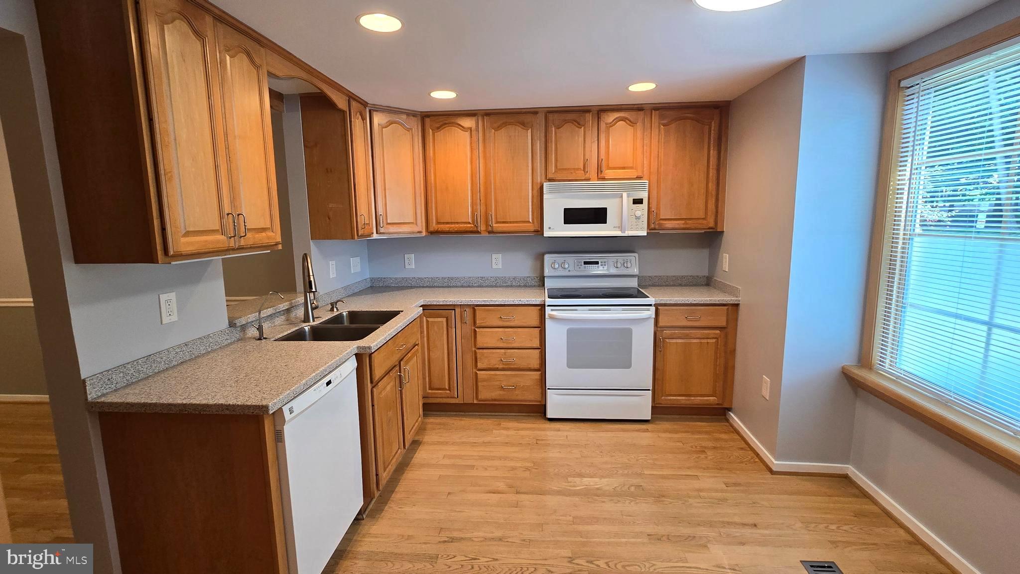 5987 Clerkenwell Court Burke, VA 22015 - Photo 7 of 41 a kitchen with a sink stove top oven and refrigerator