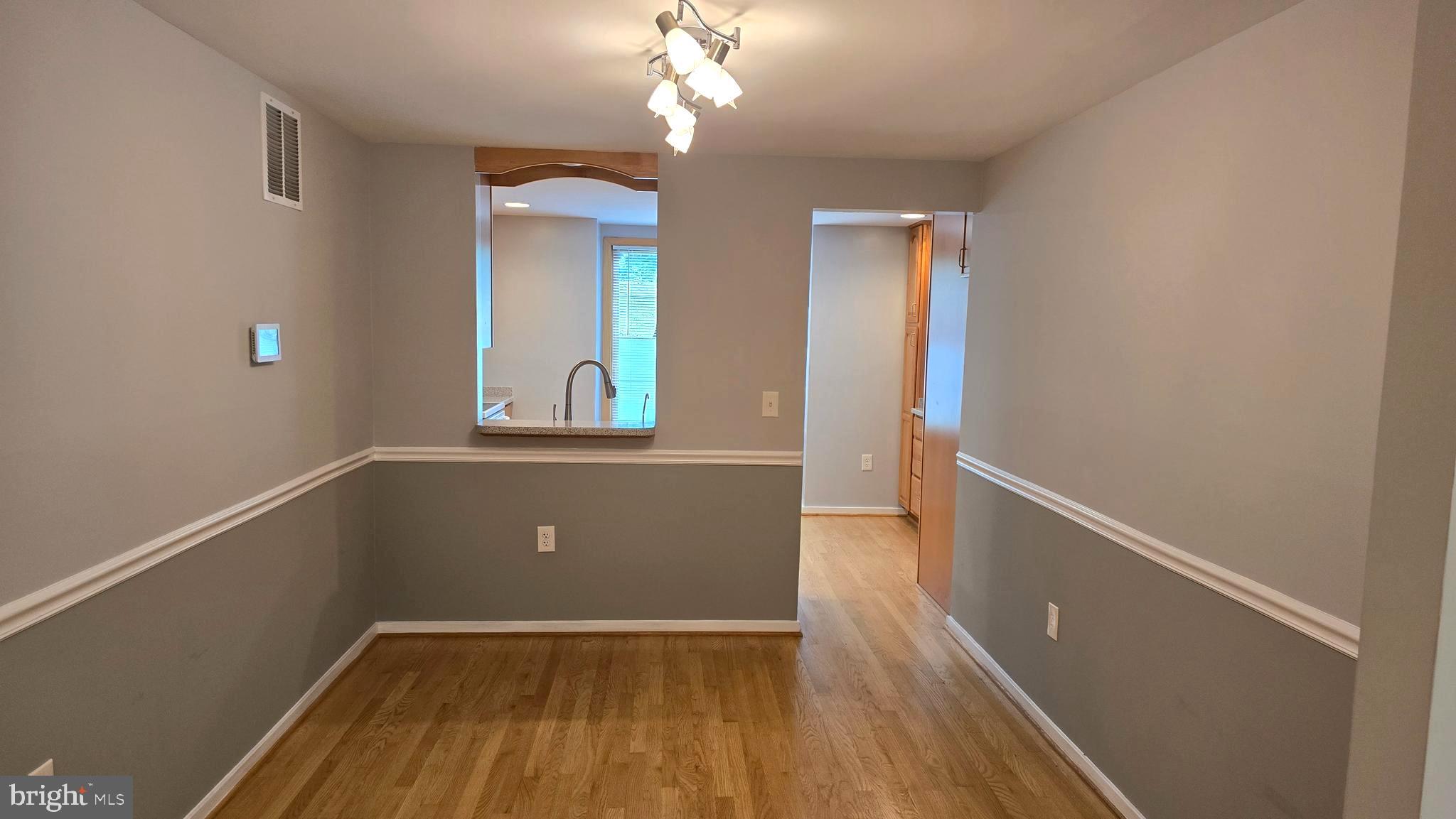 5987 Clerkenwell Court Burke, VA 22015 - Photo 8 of 41 wooden floor in an empty room with a window