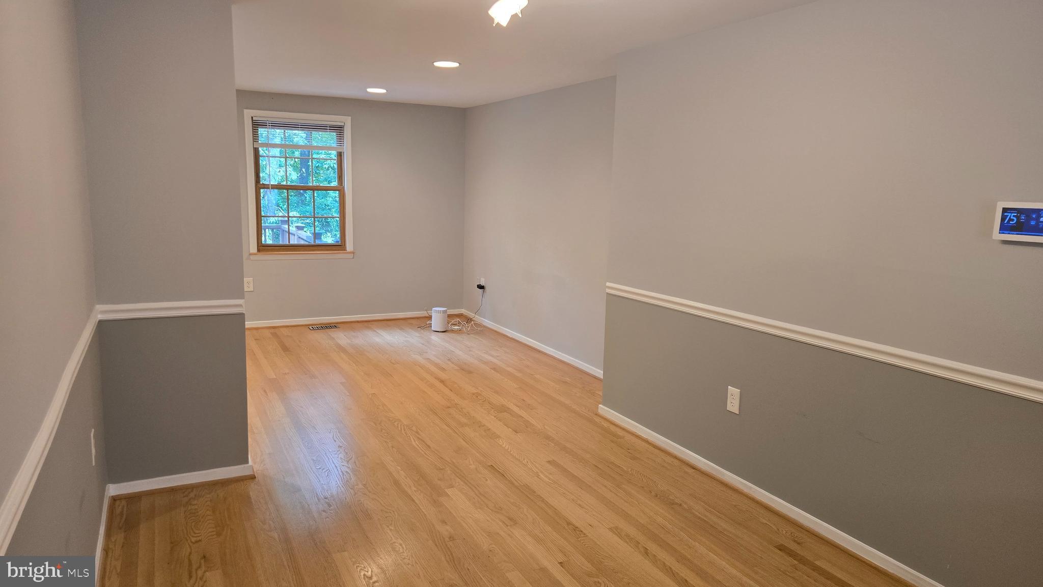 5987 Clerkenwell Court Burke, VA 22015 - Photo 9 of 41 an empty room with wooden floor and windows