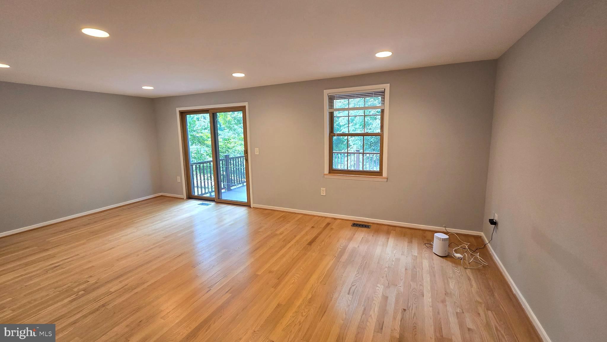 5987 Clerkenwell Court Burke, VA 22015 - Photo 10 of 41 an empty room with wooden floor and windows