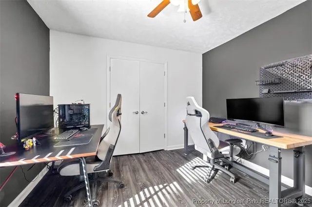 a view of a workspace with furniture and wooden floor