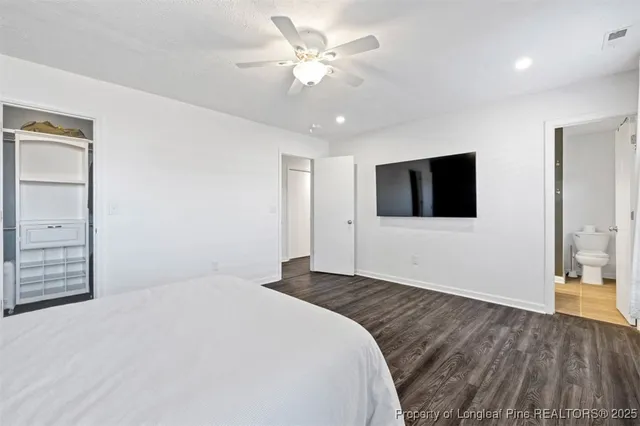 a bedroom with a bed and a flat tv screen