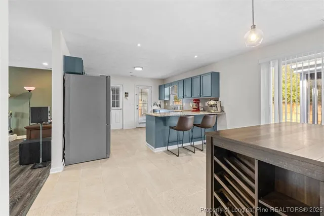 a kitchen with stainless steel appliances a refrigerator and a stove top oven