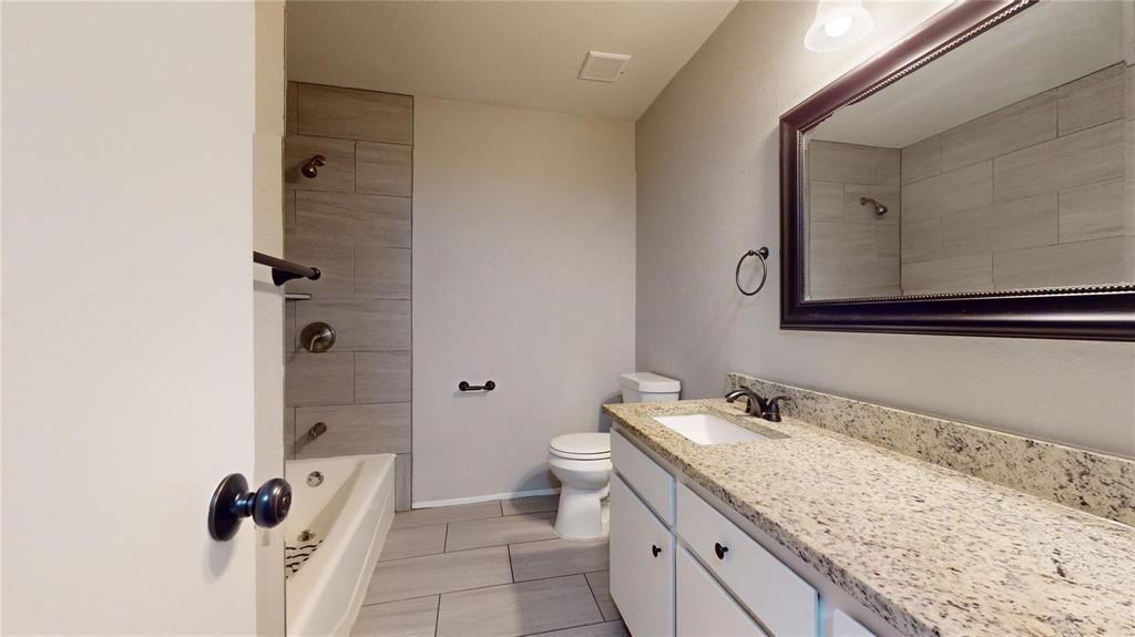 7700 Chapin Road, Unit 5 Fort Worth, TX 76116 - Photo 9 of 12 Extended vanity with a light-toned countertop, under-mount sink, and dark-finished faucet