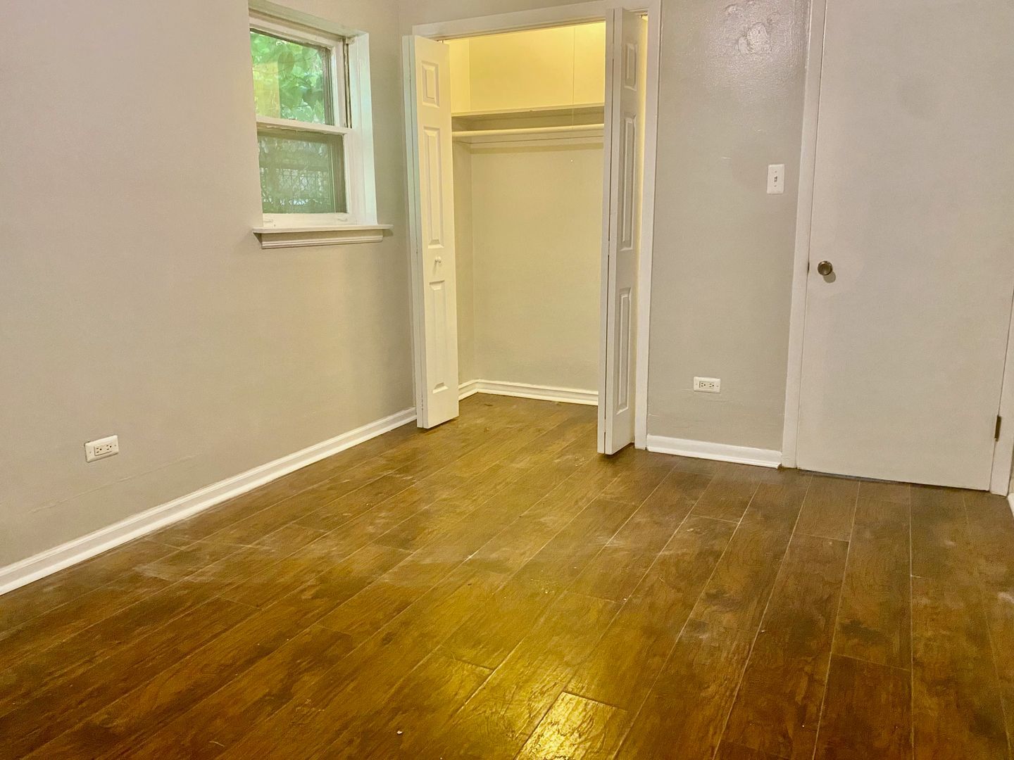 10924 South Indiana Avenue, Unit G Chicago, IL 60628 - Photo 5 of 9 an empty room with windows