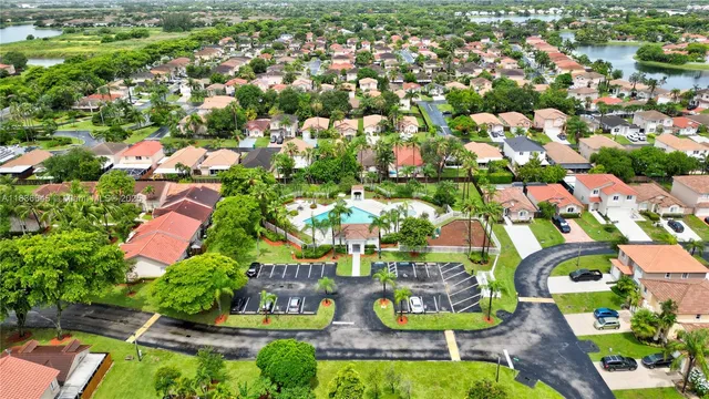 an aerial view of residential houses with outdoor space and swimming pool