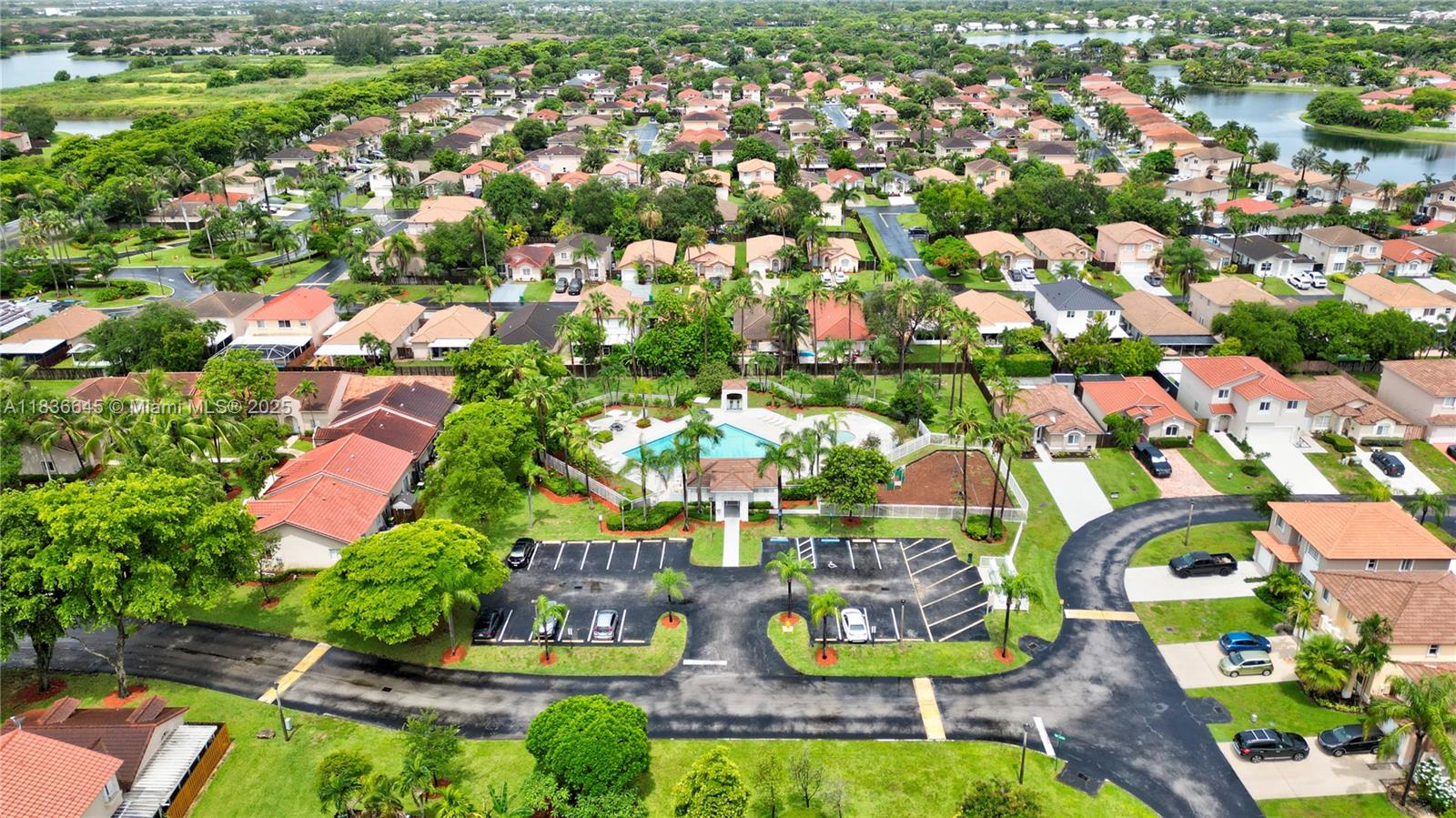 an aerial view of residential houses with outdoor space and swimming pool