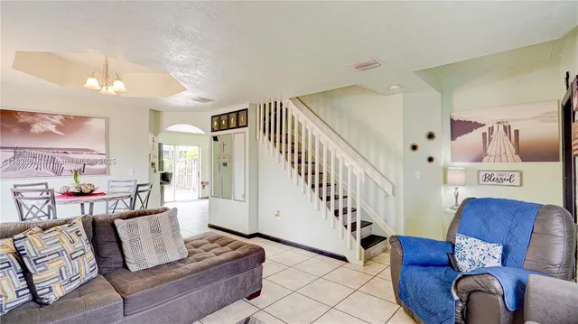 a living room with furniture and stairs