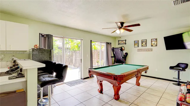 a living room with furniture a rug and a flat screen tv