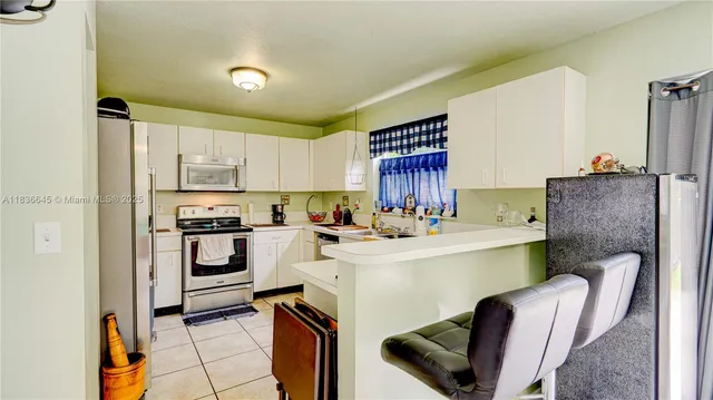 a kitchen with a sink appliances and cabinets