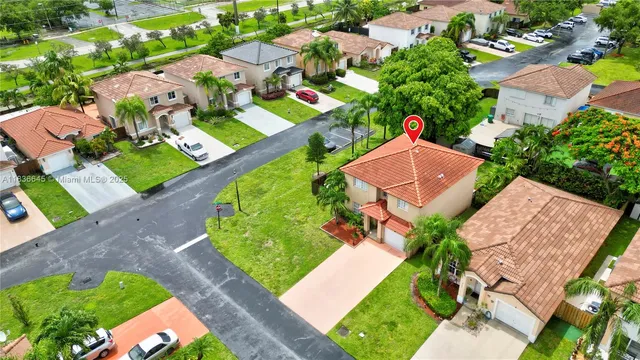 an aerial view of a house with a garden and swimming pool